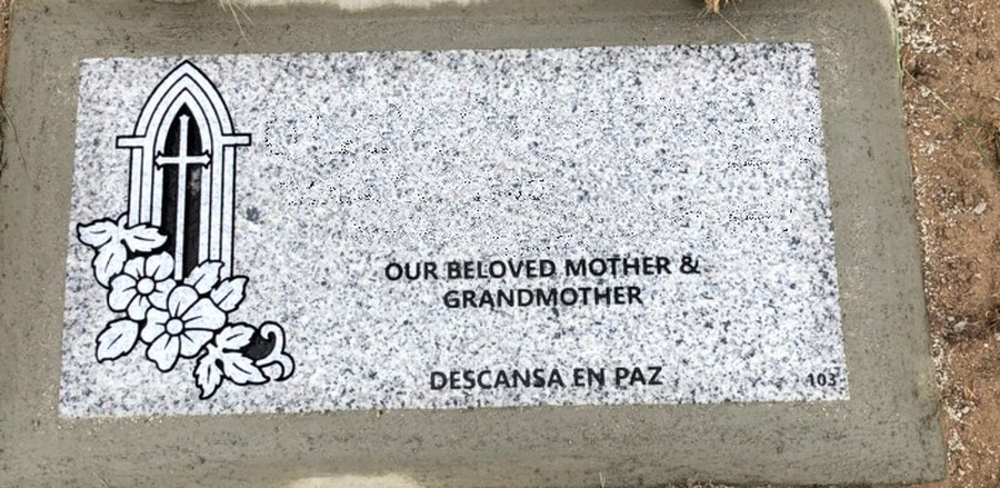 A flat marker in light grey granite set flush with the ground