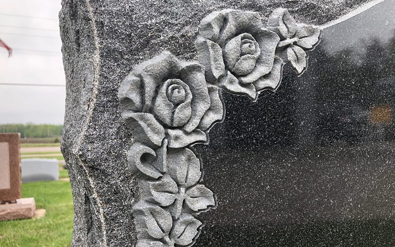 Roses carved in relief along the edge of a monument