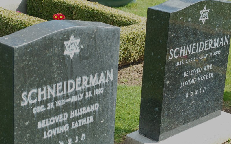 A husband and wife&rsquo;s headstones side by side, hers newly cleaned