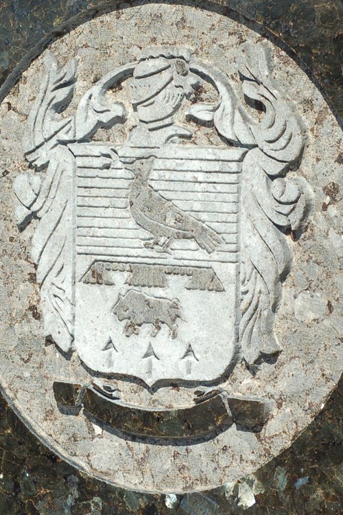 A family crest carved as a medallion in granite
